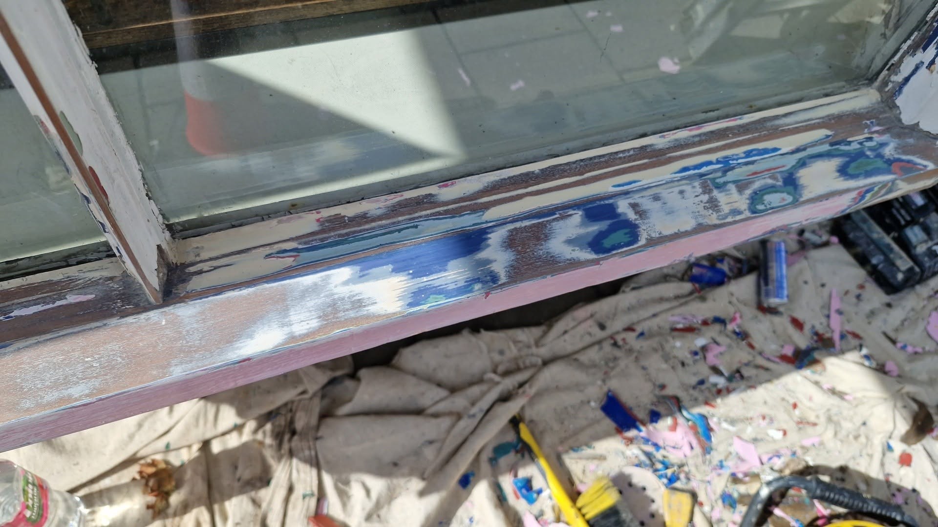 Window sill stripped back during preparation, with tools on a dust sheet