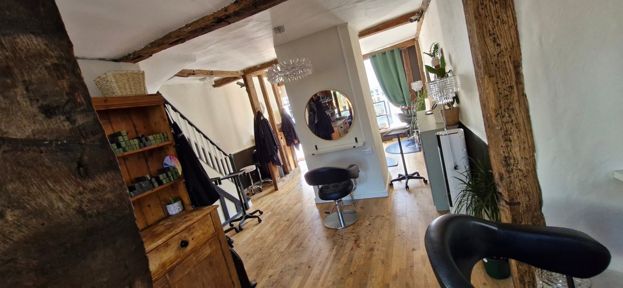 Bright interior with white walls, exposed beams and salon chairs