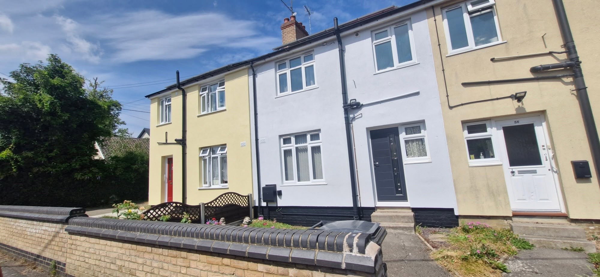 Terrace of houses with the middle house freshly painted white