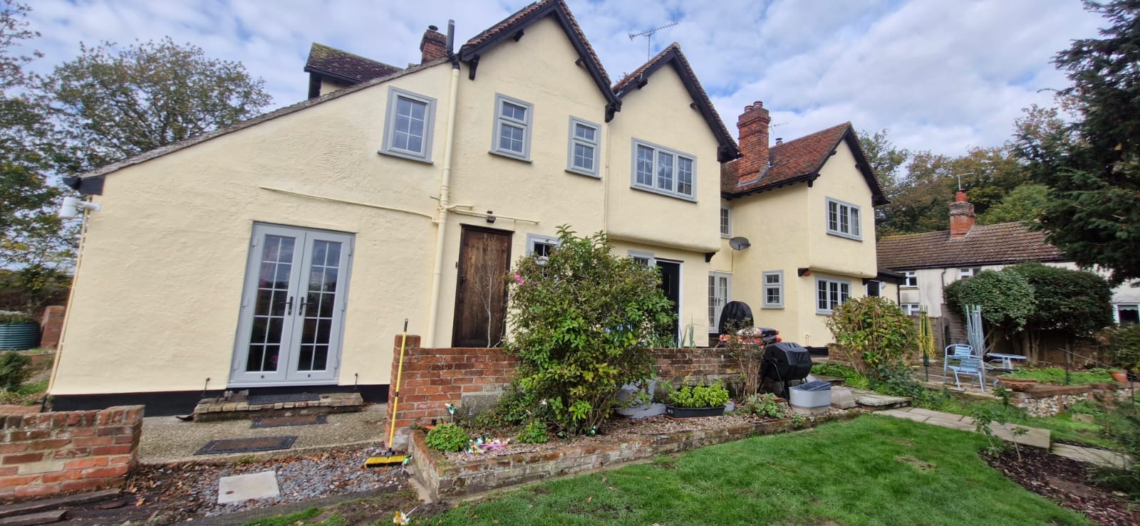 Cream-rendered period house with grey window frames after an exterior repaint by LPS Decorating Services